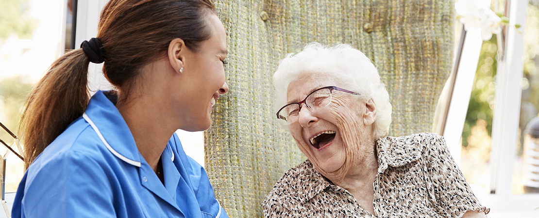 elderly lady and carer laughing