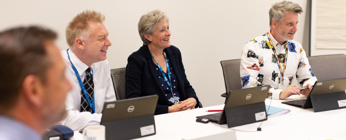 colleagues talking around a table