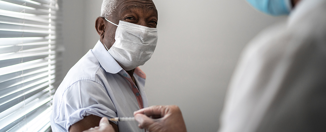 Elderly man being vaccinated