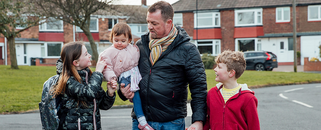 Family walking together in a housing estate