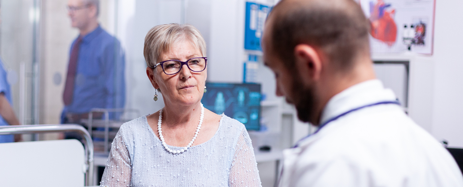 A patient listening to a doctor in a hospital