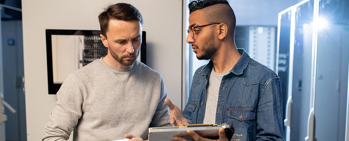 Two work colleagues looking at a laptop