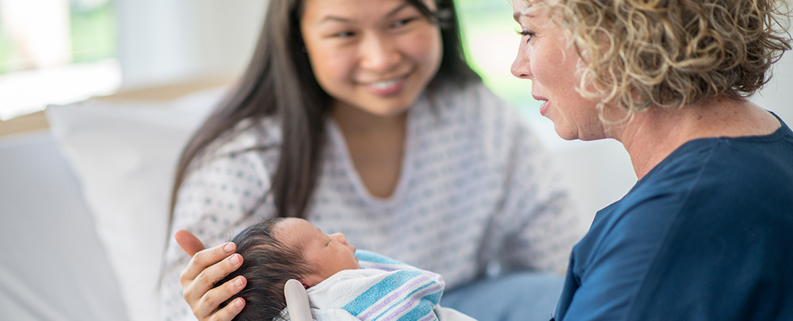 midwife with mother and baby