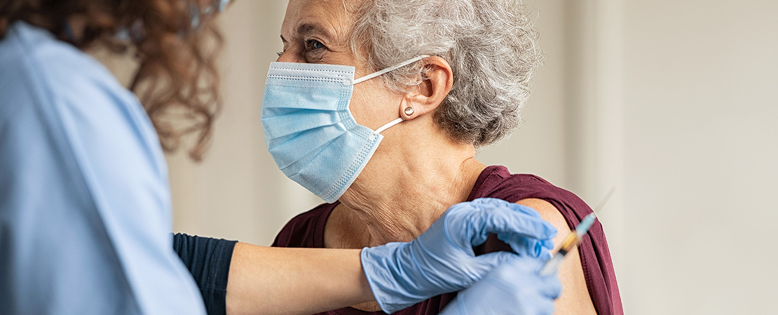 Elderly lady being vaccinated