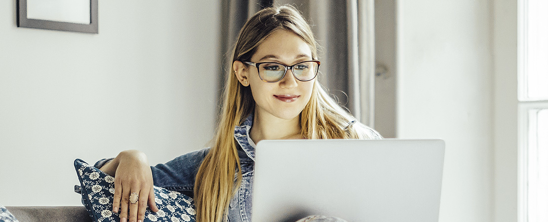 Woman looking at her laptop at home