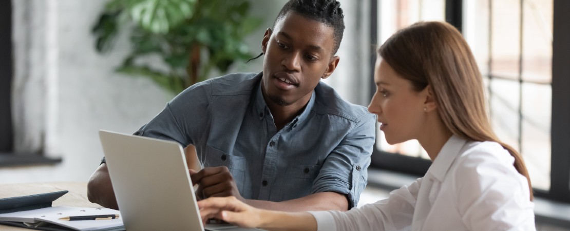 two colleagues working together on a laptop