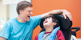 Carer and child in a wheelchair