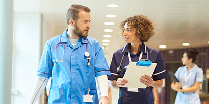 two hospital staffs talking and walking together