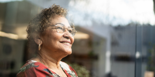 Woman smiling looking out of a window