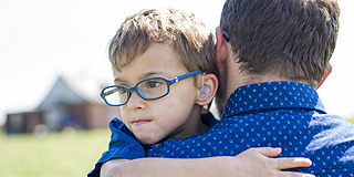 man carrying child
