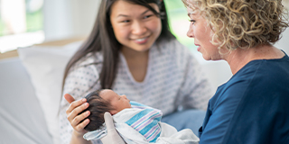 midwife with mother and baby