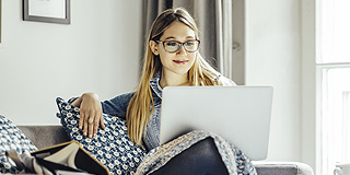 Woman looking at her laptop at home