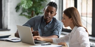 two work colleagues on a laptop